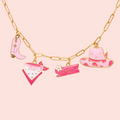 Necklace with colorful charms on a pink background
