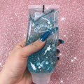 Hand holding a glittery blue hand sanitizer with 'Chiboka' branding.