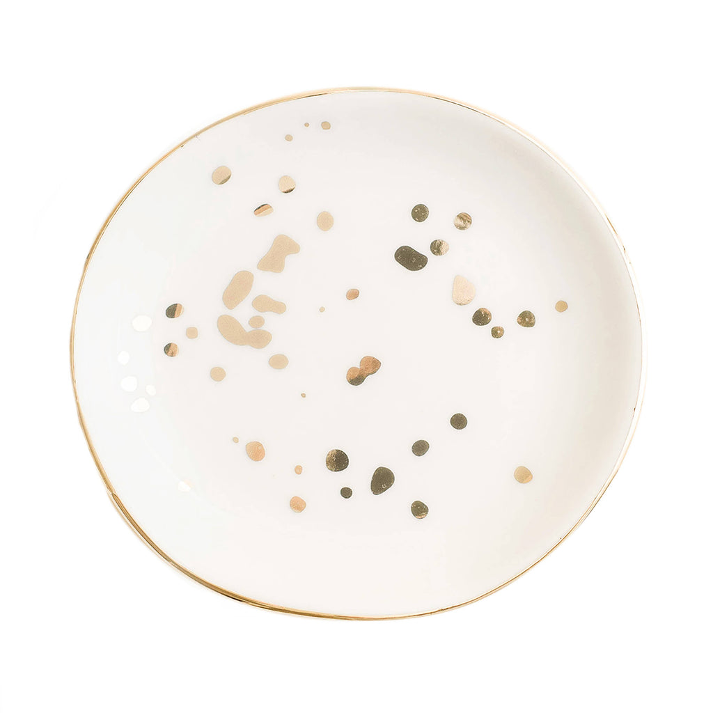 White ceramic plate with gold and green speckles on a white background