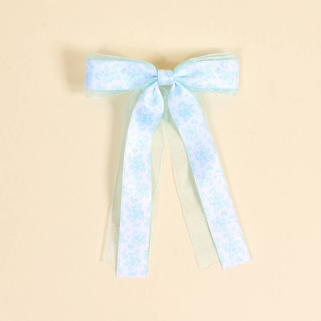 Light blue and white checkered bow on a beige background