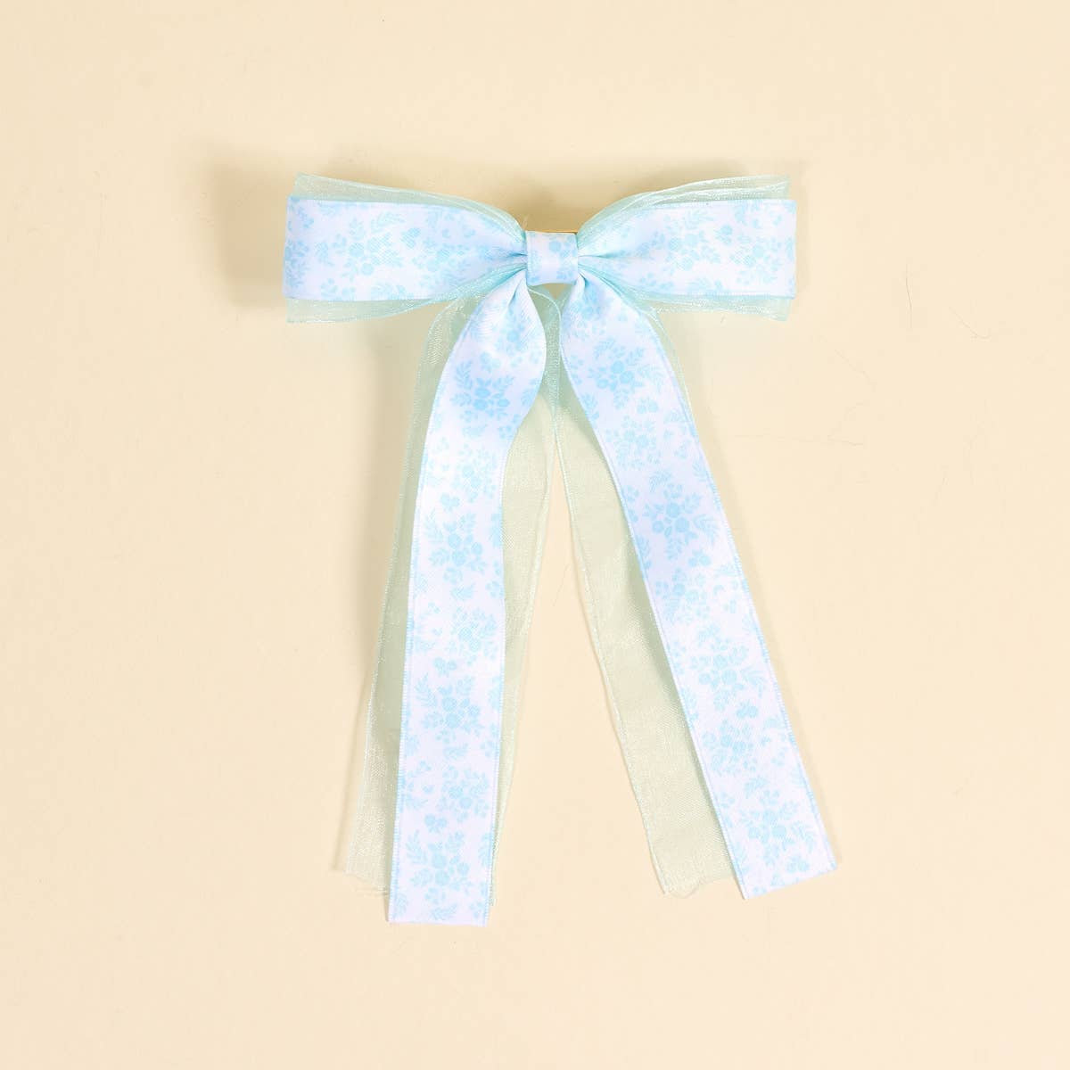 Light blue and white checkered bow on a beige background