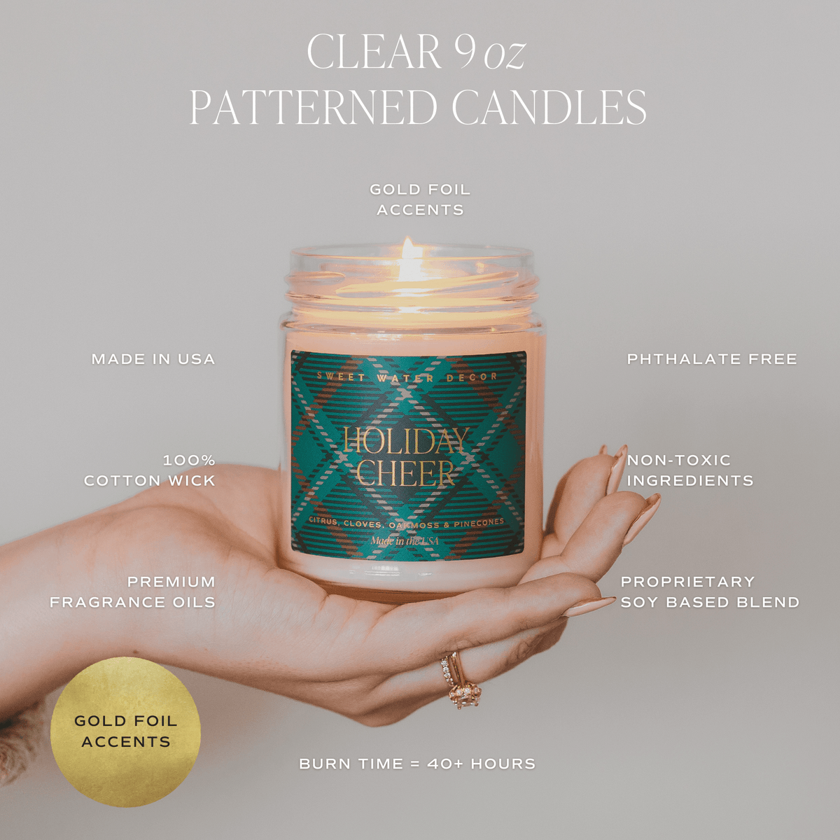 Hand holding a Holiday Cheer candle with gold foil accents; graphic highlights a soy-based blend, cotton wick and 40+ hour burn time.