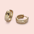 True North gold huggie hoop earrings with engraved North Star detailing