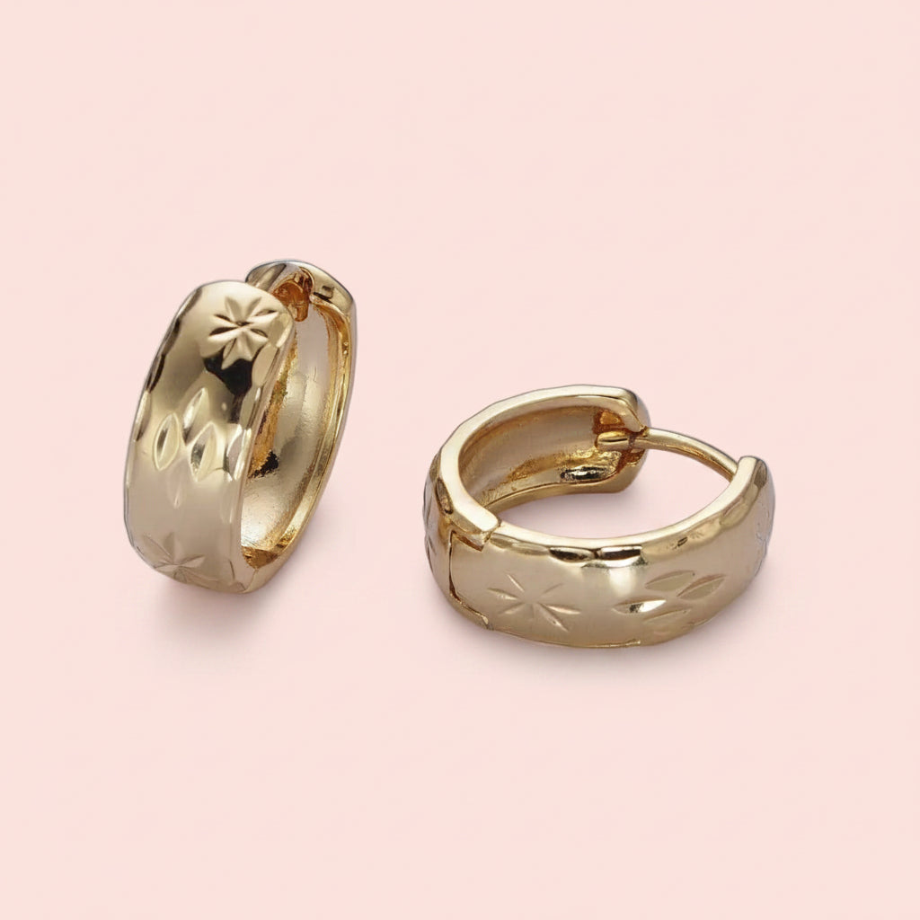 True North gold huggie hoop earrings with engraved North Star detailing