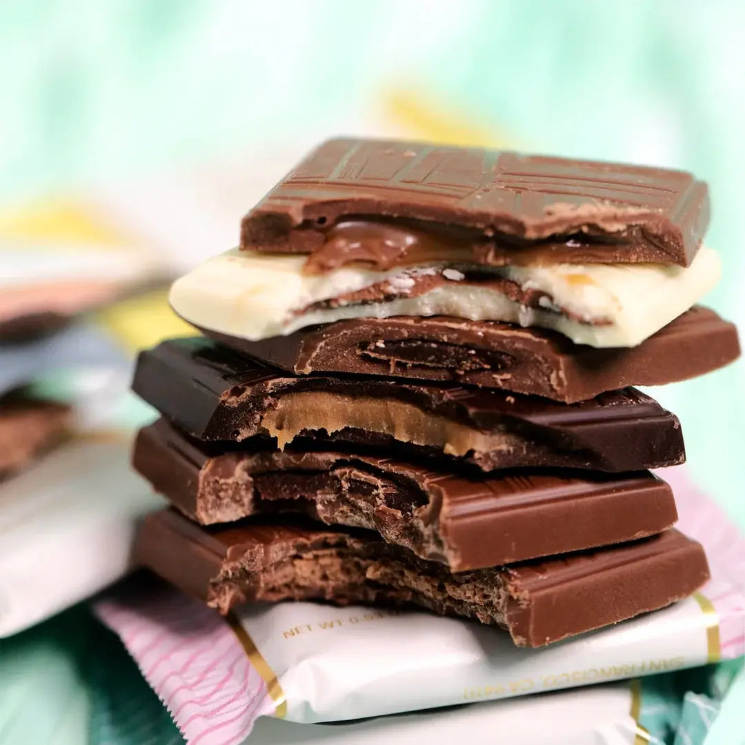 Stack of chocolate bars with visible layers on a colorful background