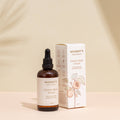Mummy's Organics stretch mark serum bottle and packaging on a beige background