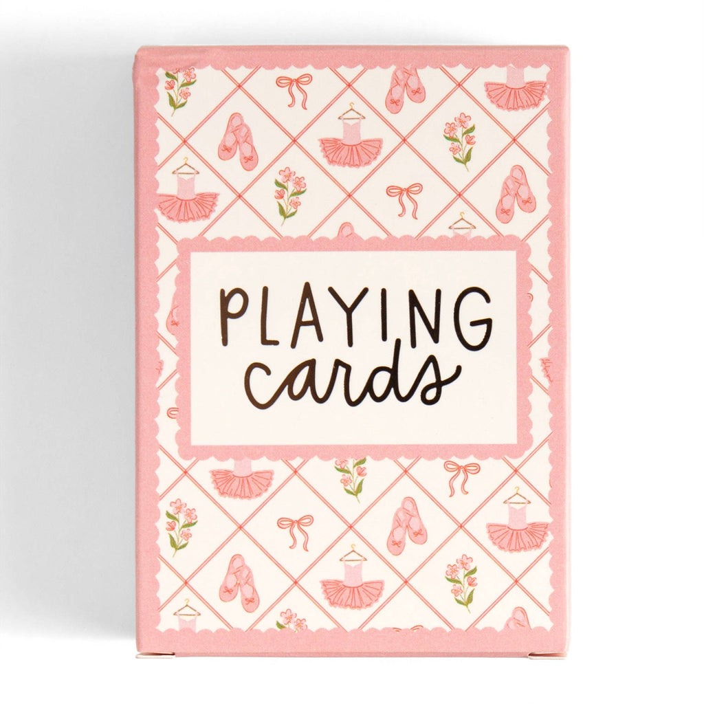 A pink and white box of playing cards decorated with ballet dancer motifs, including tutus, pointe shoes, bows, and flowers, with the text 'PLAYING cards' in the center.