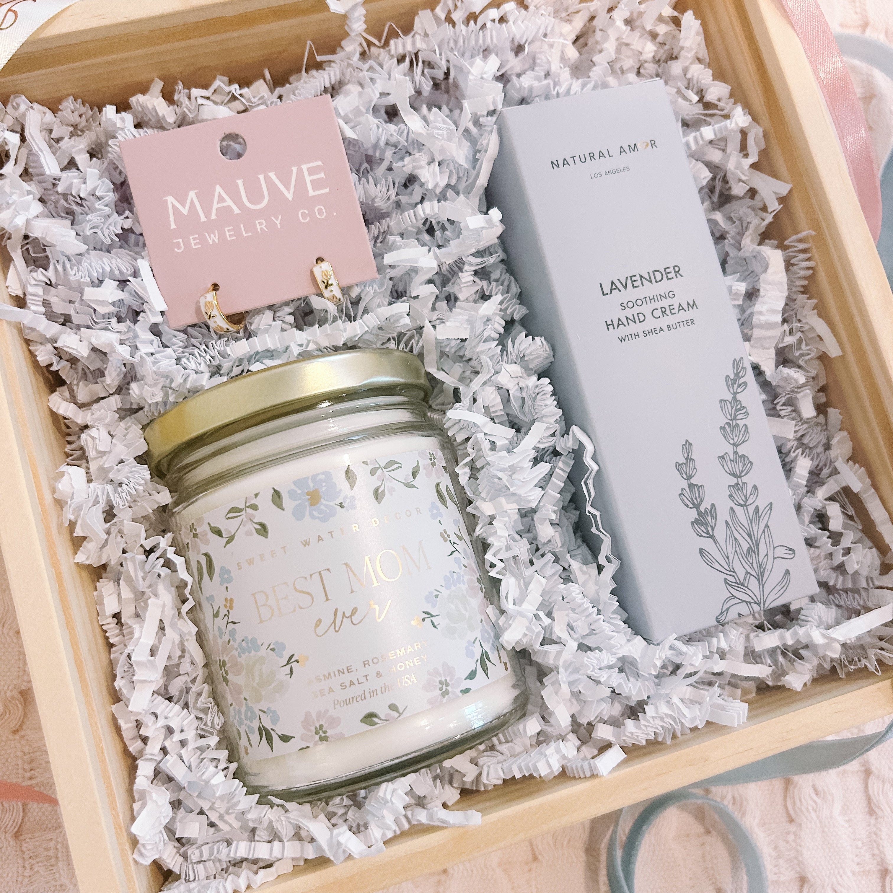 Gift set with candle, hand cream, and earrings in a wooden box.