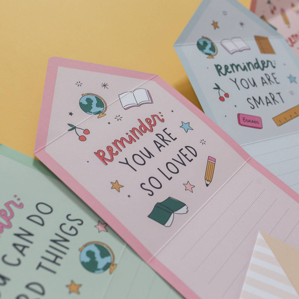 Motivational cards with messages like 'Remember you are so loved' on a colorful background