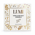 LUMI Vanilla Sea Salt Caramels packaging box, featuring a cream-colored front with elegant gold botanical illustrations and a central gold-bordered label with black text.