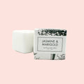 Bar of soap with a packaging box labeled 'Jasmine & Marigold' on a white background