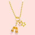 Necklace with ballet slipper and star charms on a white background