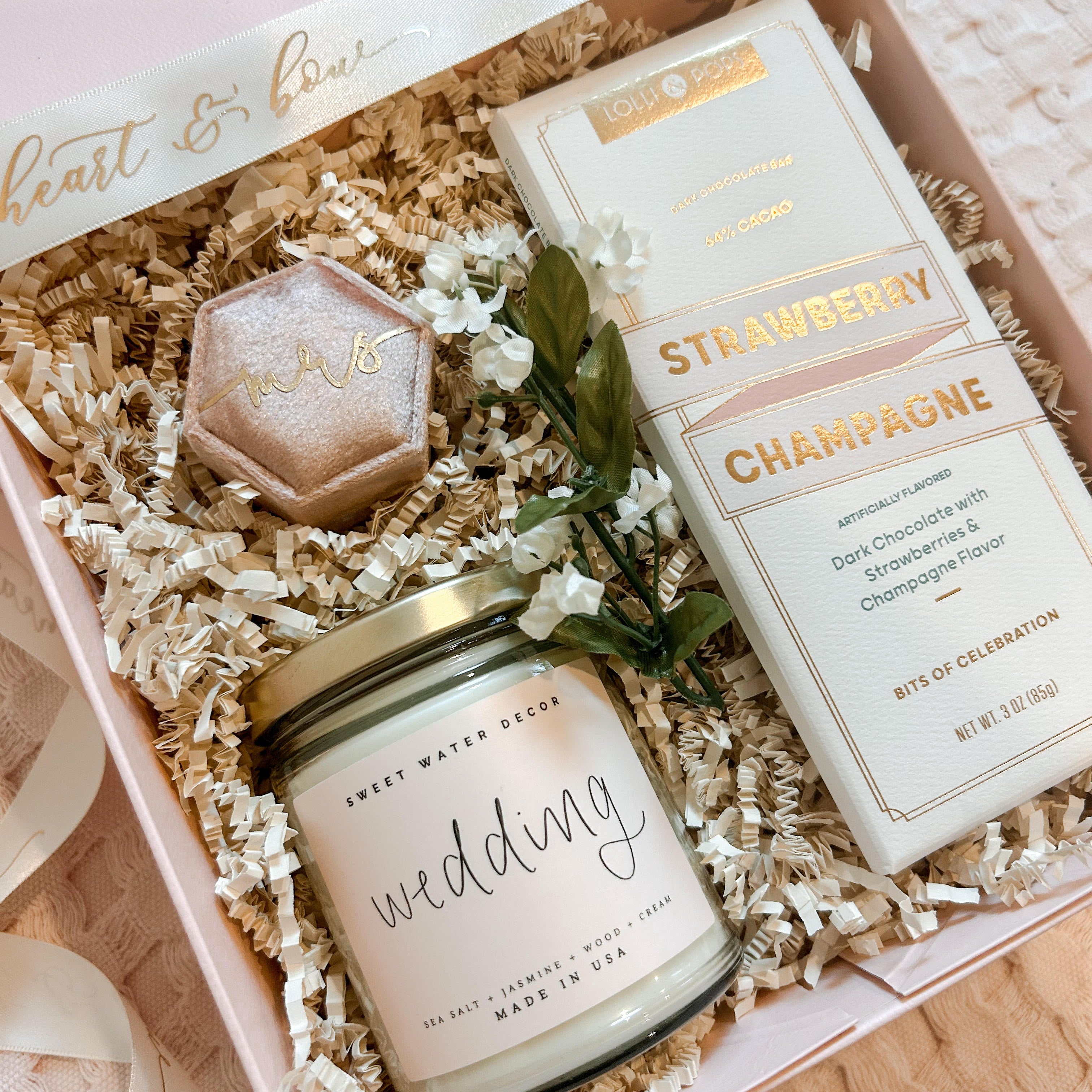 Gift set with candle, chocolate, and other items in a decorative box.