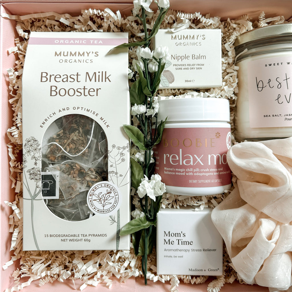 Gift box with breast milk booster, relax me cream, and other products on a light background