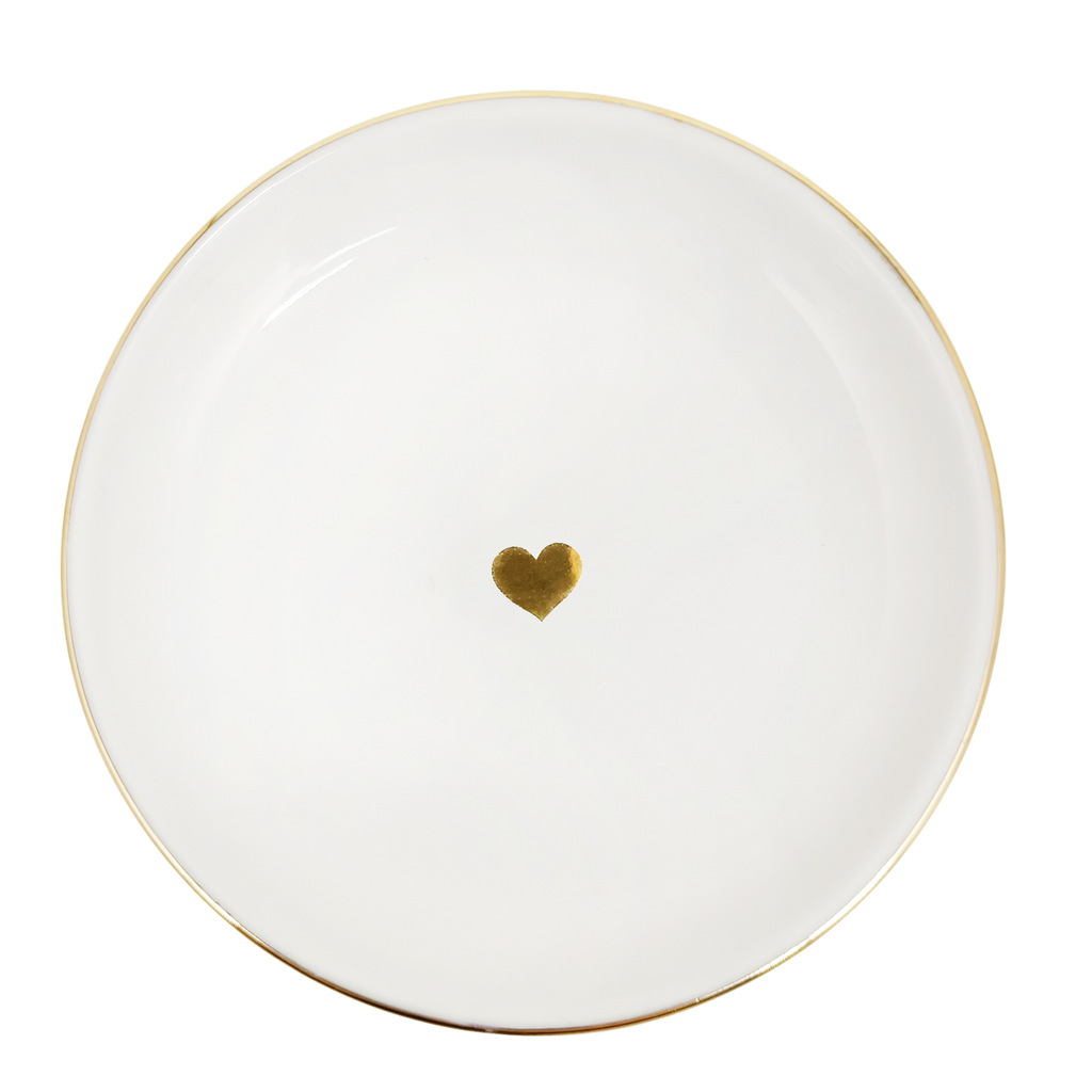White plate with a gold heart design on a white background
