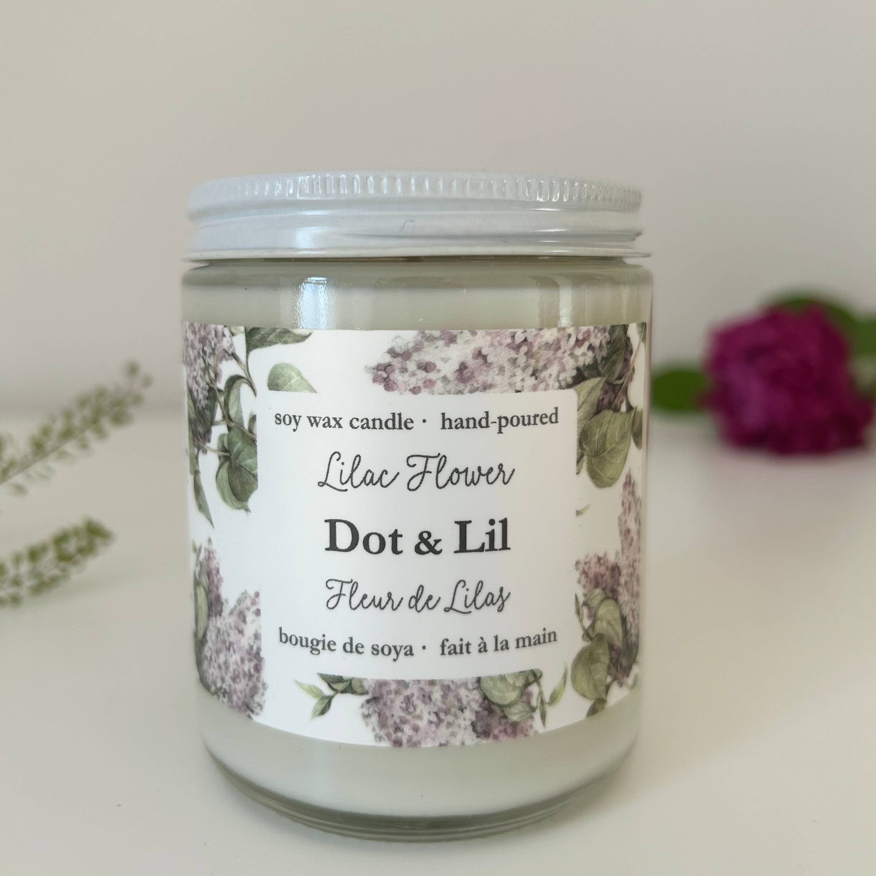 Candle jar labeled 'Dot & Lil' with a floral design on a white background