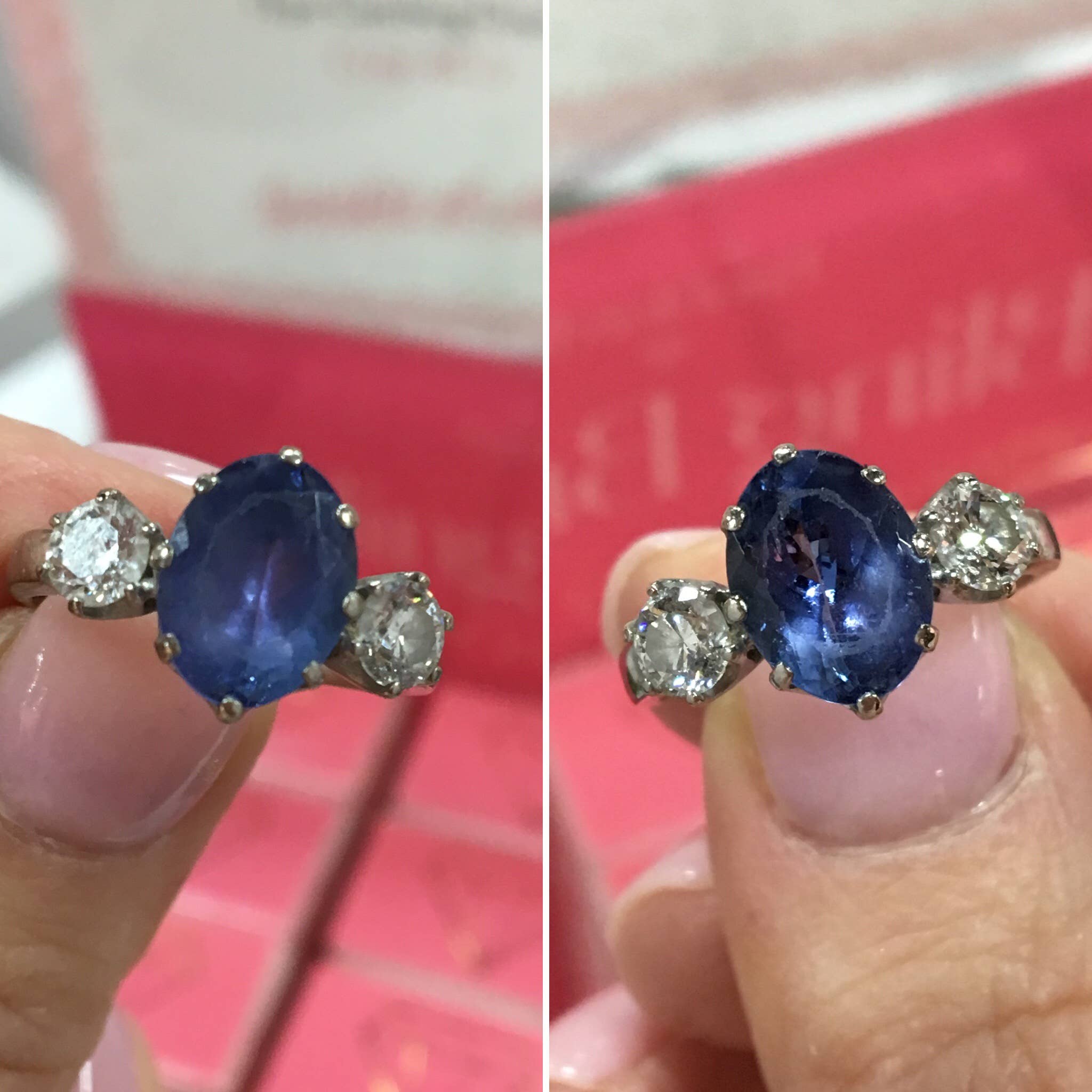Pair of sapphire and diamond earrings held between fingers with a blurred background.