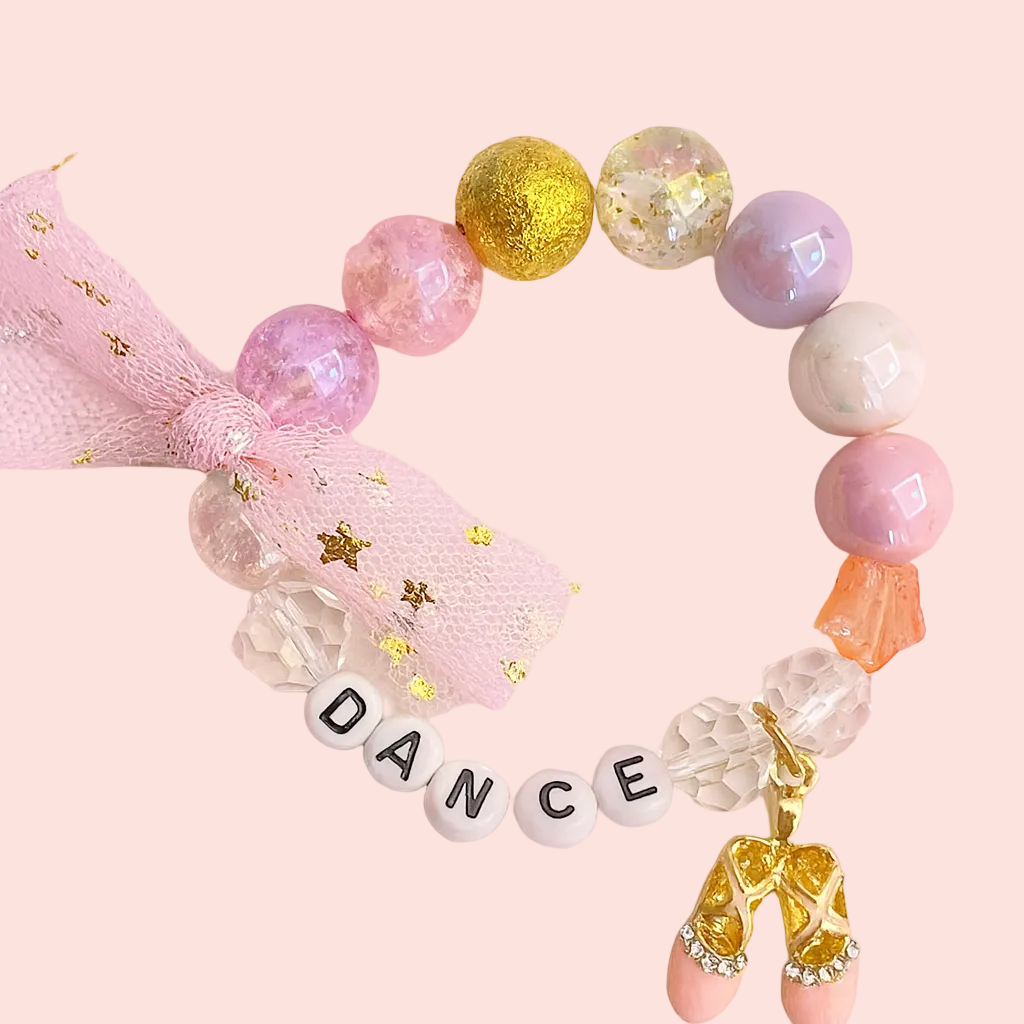Colorful beaded bracelet with 'DANCE' charm on a pink background
