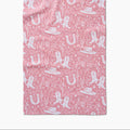 Pink western tea towel with white cowboy boots, hats, horseshoes and cactus pattern