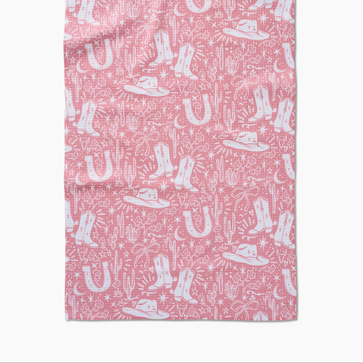 Pink western tea towel with white cowboy boots, hats, horseshoes and cactus pattern
