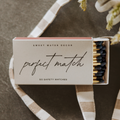Matchbox labeled 'Perfect Match' by Sweet Water Decor on a textured surface with a checkered ribbon.