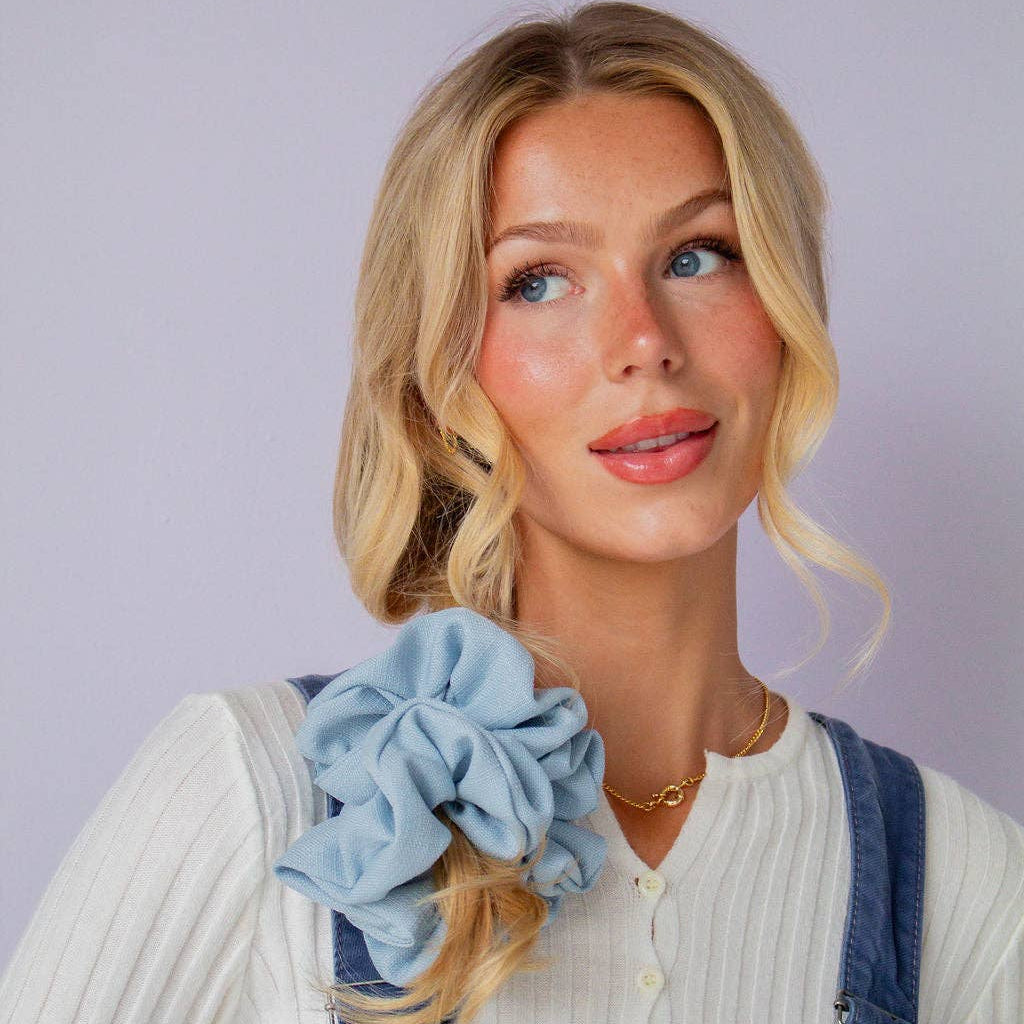 Woman wearing the Powder Blue Jumbo Scrunchie in her hair.