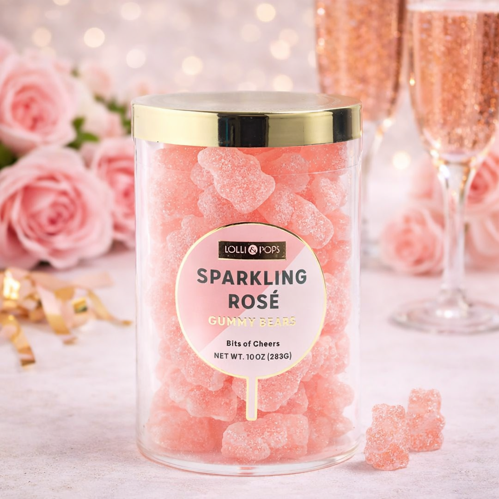 Jar of sparkling rose gummy bears with pink roses and champagne glasses in the background