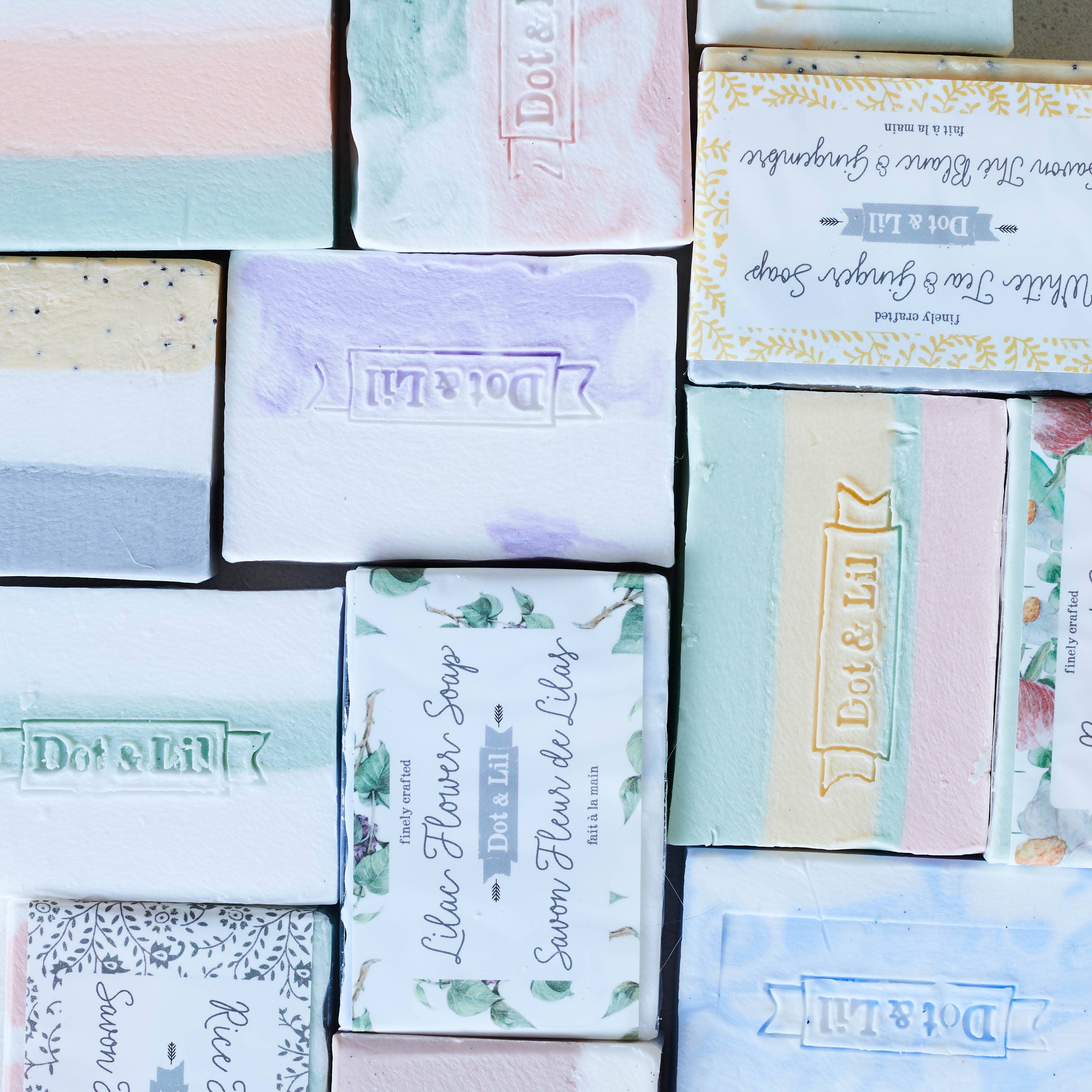 Collection of Dote & Lilac soap bars with various designs and branding.