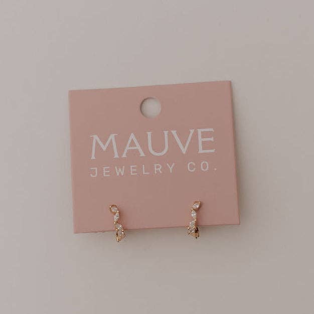 Pair of earrings on a Mauve Jewelry Co. card against a light background