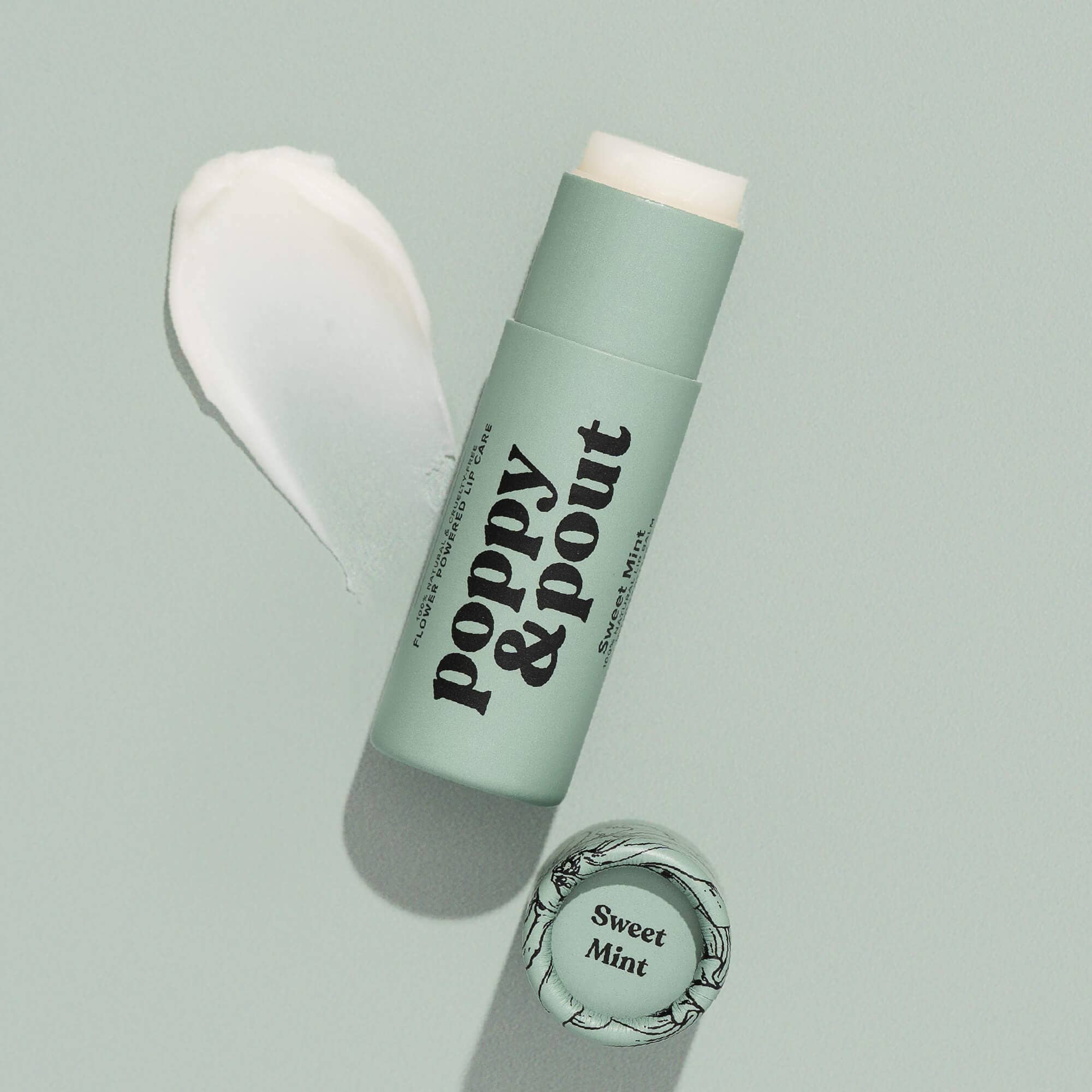 Green lip balm stick with 'Poppy & Pout' branding on a light gray background
