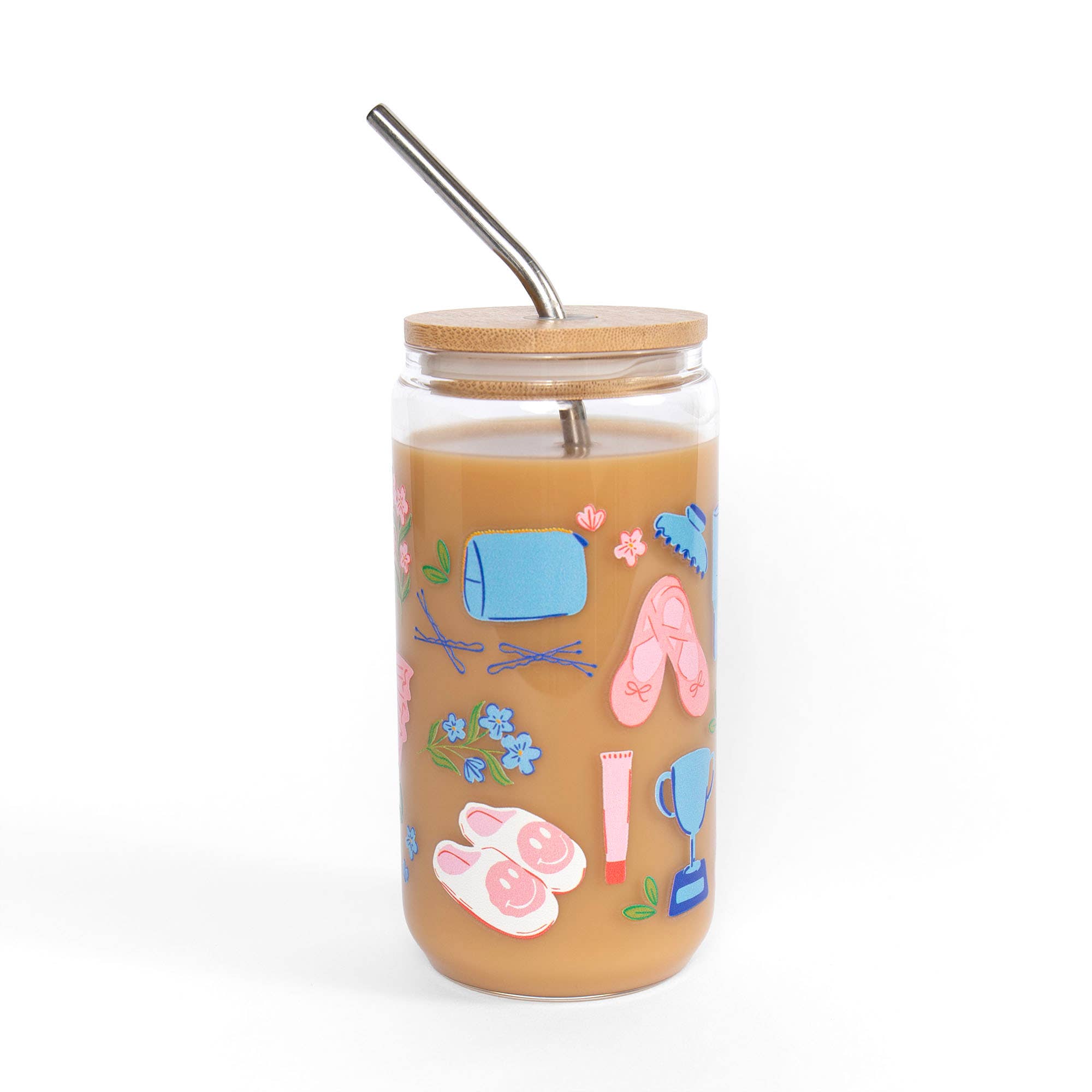 A clear glass tumbler with a bamboo lid and metal straw, filled with an iced coffee drink and decorated with colorful fitness-themed illustrations including a blue dumbbell, pink flip-flops, pink heart-shaped sandals, and a blue and pink water bottle, on a white background.