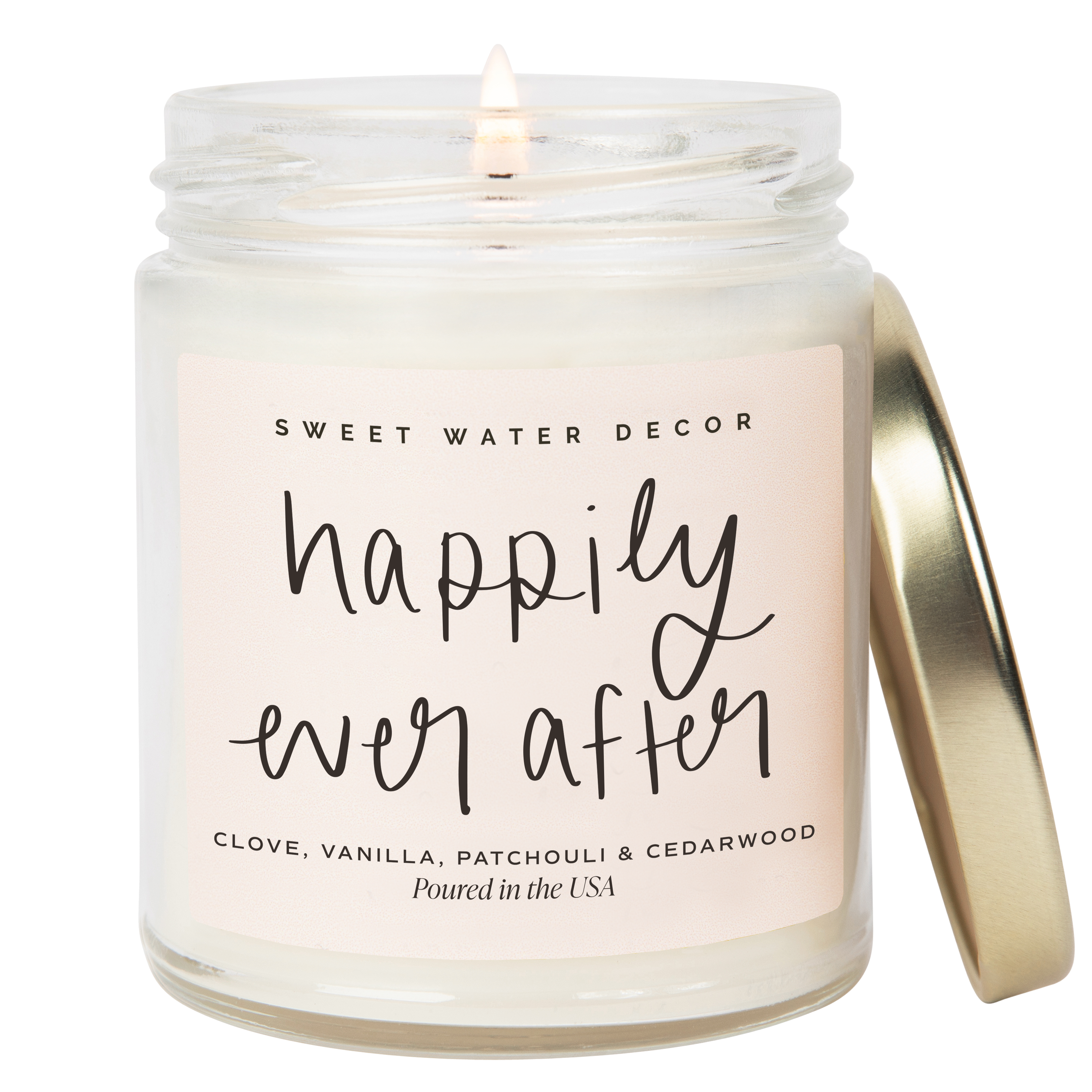 Candle in a glass jar with a gold lid labeled 'Happily Ever After' by Sweet Water Decor.