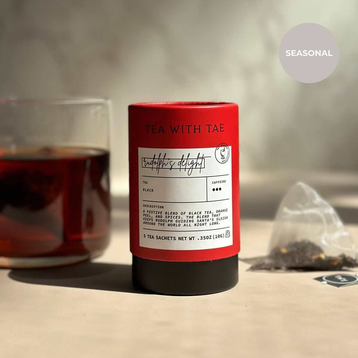 Red cylindrical tea packaging with a label on a blurred background
