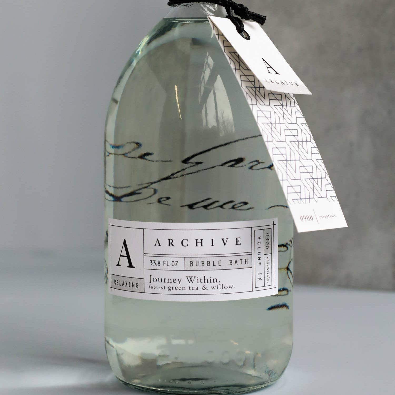 Clear bottle with a label on a gray background