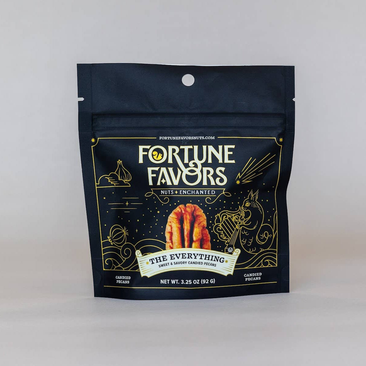 Fortune Favors 'The Everything' garden flavor milk chocolate in a dark navy blue resealable pouch with gold and white lettering, set against a plain light gray background.