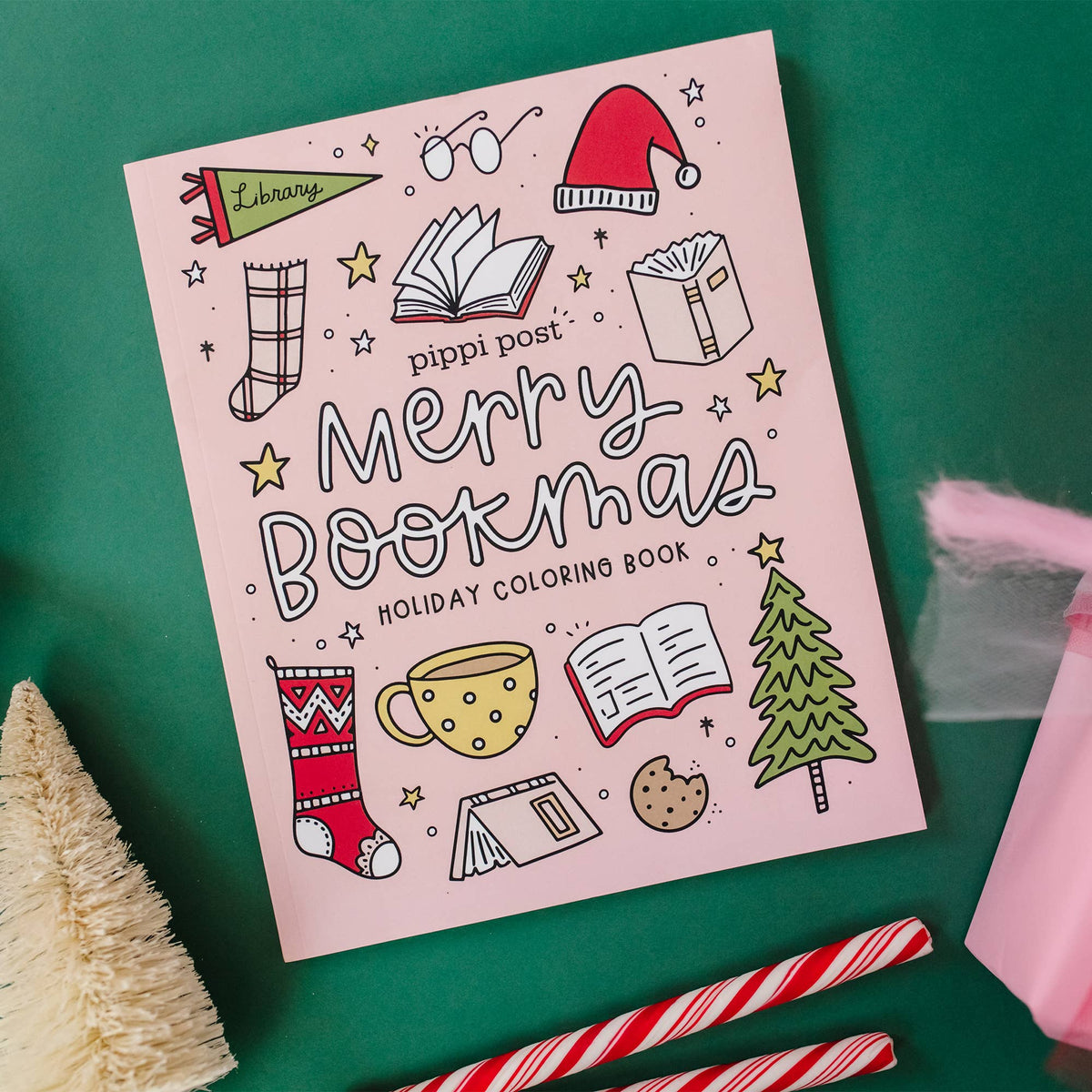 Coloring book titled 'Merry Bookmas' on a green background with Christmas-themed illustrations.