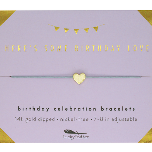 Bracelet packaging with gold heart charm and text on a purple background