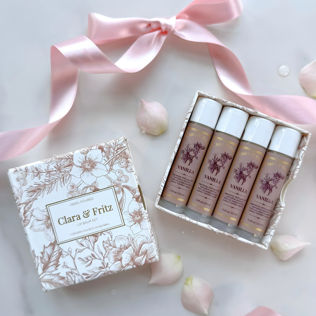 Set of skincare products with a decorative box and pink ribbon on a light background