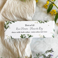 Dot & Lil rice flower milk bath cubes packaging on a marble surface with flowers and a towel.