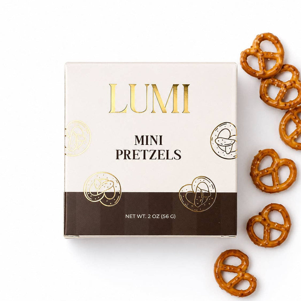 LUMI Classic Mini Pretzels 2 oz cream and brown box with gold lettering beside salted mini pretzels on a white background.
