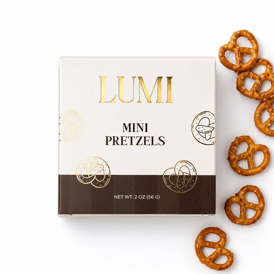 LUMI Classic Mini Pretzels 2 oz cream and brown box with gold lettering beside salted mini pretzels on a white background.
