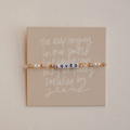 Bracelet with 'LOVED' beads on a card with text