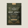 Rogue Beef Jerky packaging with green and brown design on a beige background