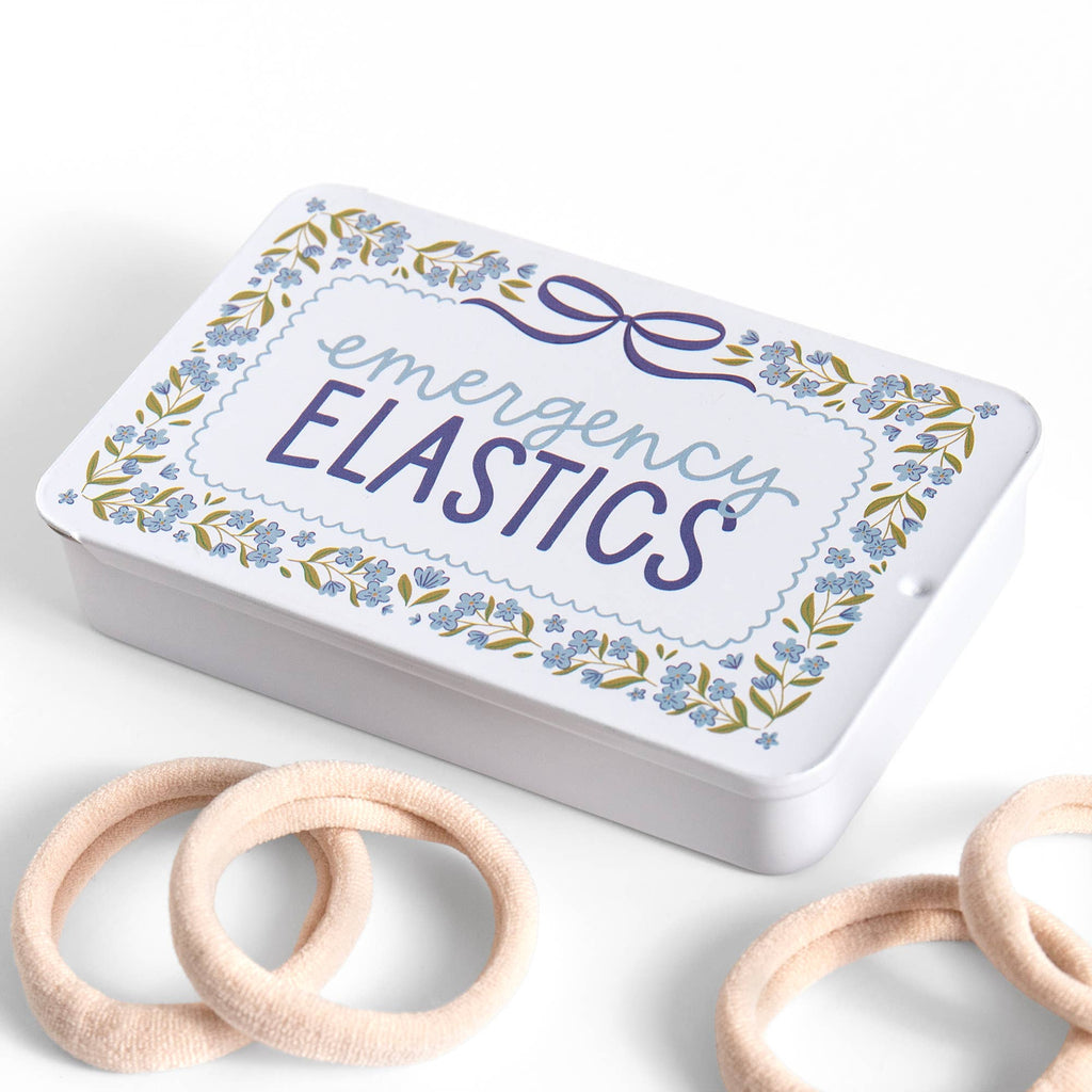 Box labeled 'emergency elastics' with wooden elastics on a white background