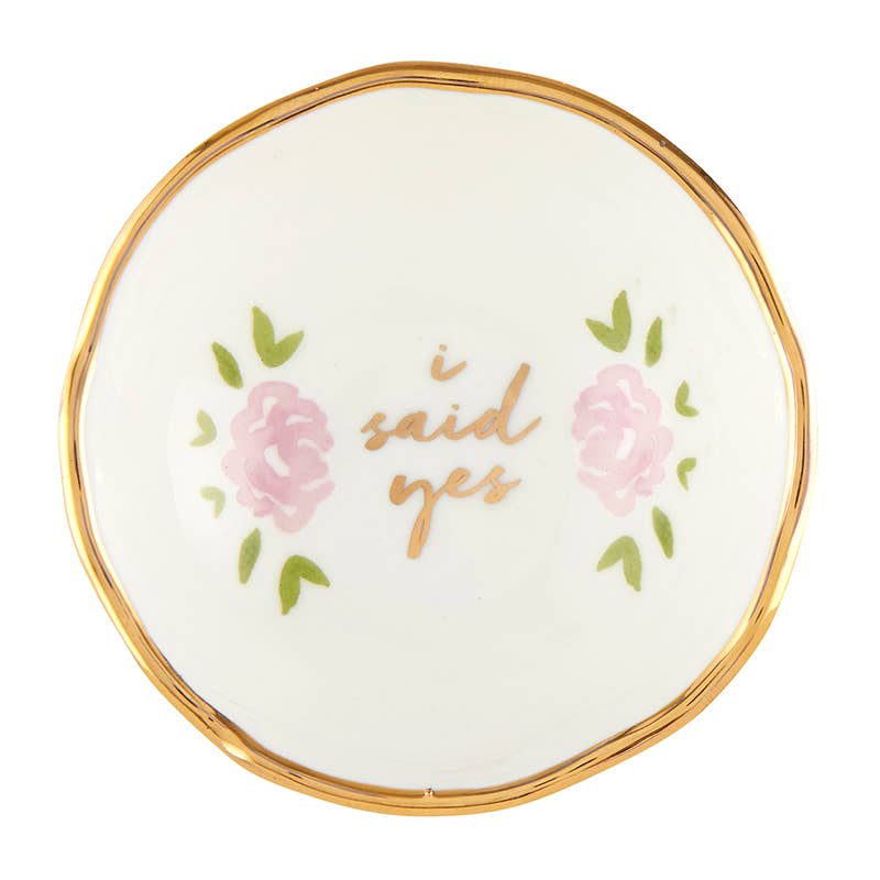 Round white dish with gold rim, pink roses, and 'i said yes' text on a white background