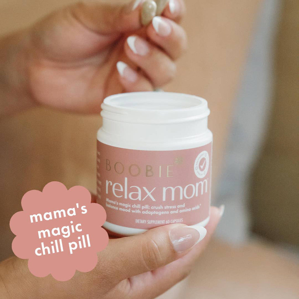 Hand holding a 'Boobie Relax Mom' product with a humorous label.