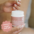 Hand holding a 'Boobie Relax Mom' product with a humorous label.