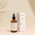 Mummy's Organics Perineal Soothing Spray bottle and packaging on a beige background