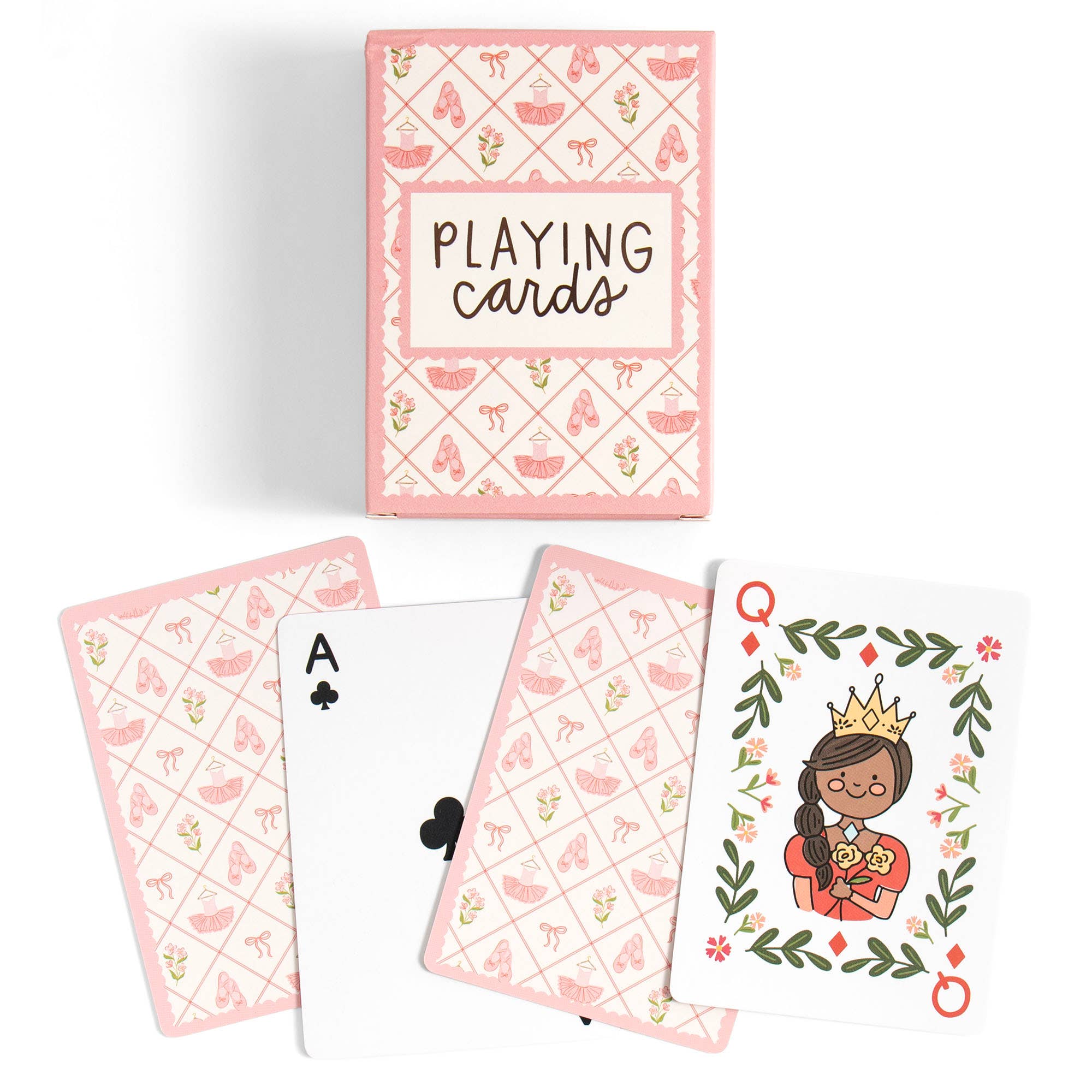 A boxed deck of playing cards with several cards fanned out below. The box and card backs have a pink patterned design with small illustrations, and one visible card shows a crowned queen illustration on a white background.
