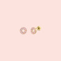 Pair of pink donut-shaped earrings on a white background